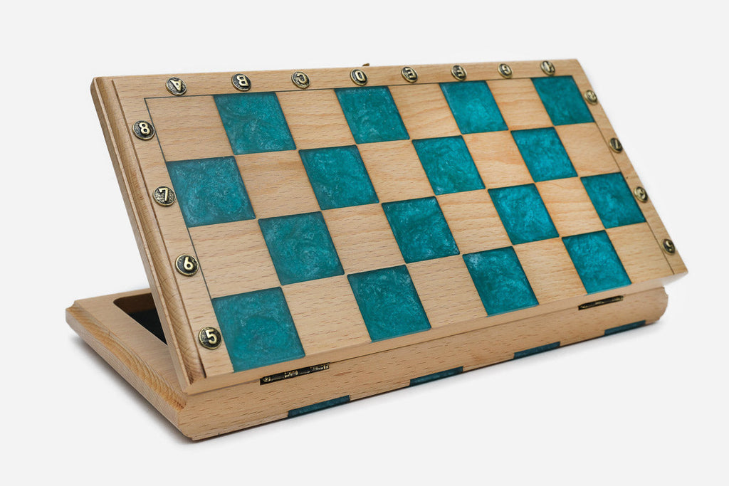 Angled view of the teal epoxy chess set with its bronze pieces