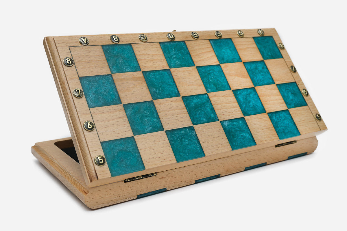 Angled view of the teal epoxy chess set with its bronze pieces
