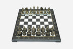 Elevated angle of the black marble chess board with bronze pieces and brass coordinate markers