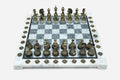 Grey and white marble chess set with hand-cast bronze pieces arranged for play and brass coordinate markers