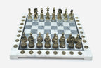 Angled view of the grey marble chess board with detailed bronze pieces set up for play
