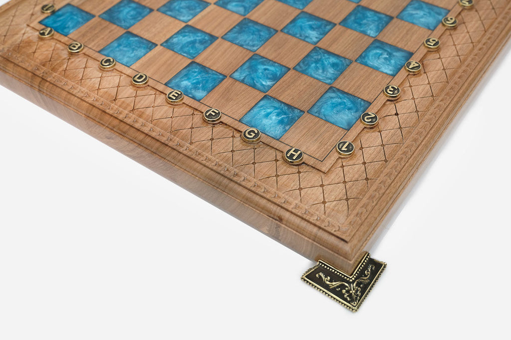 Close-up of the beech and walnut chess pieces on the blue epoxy squares