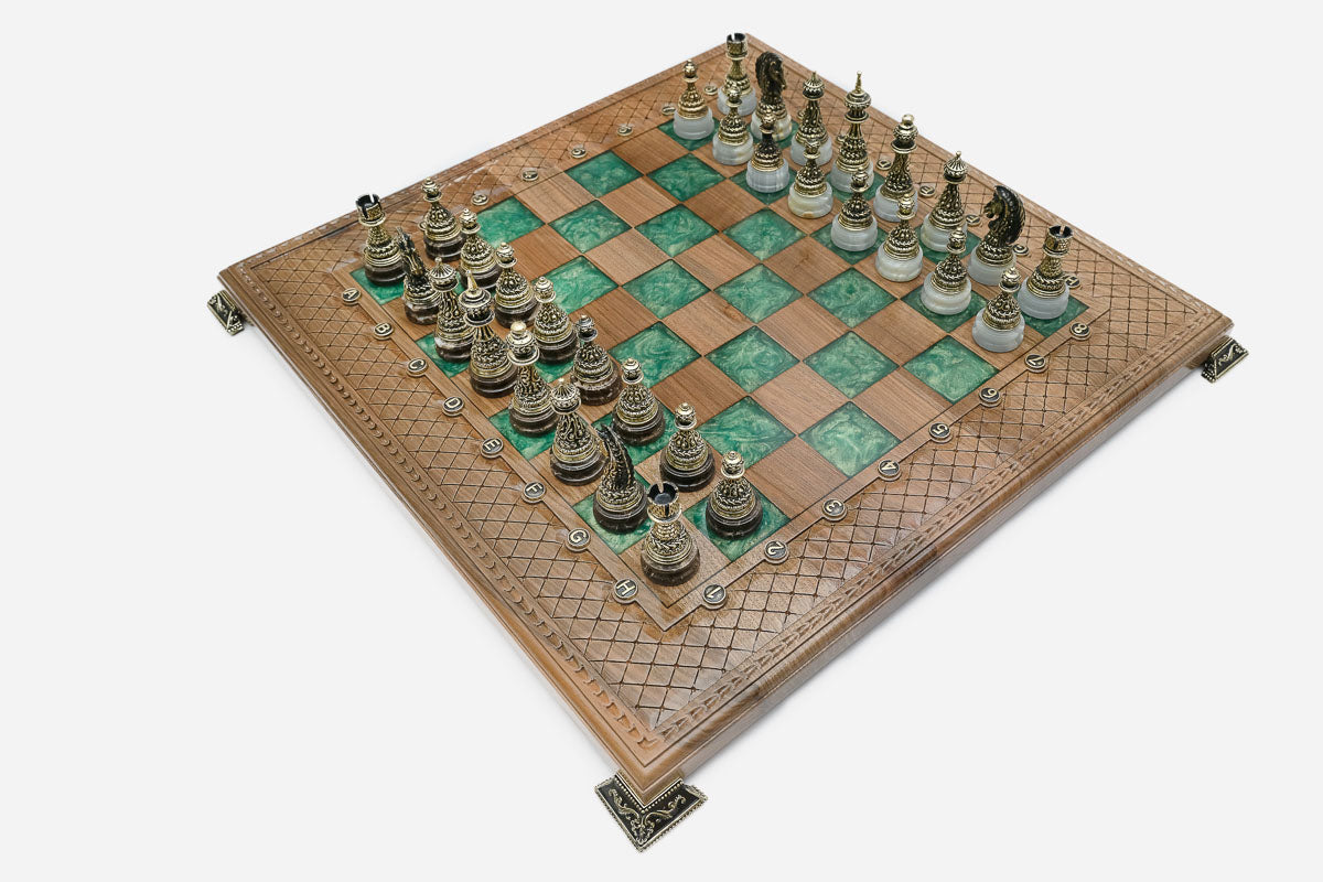 Close-up of an ornate brass corner bracket on the board