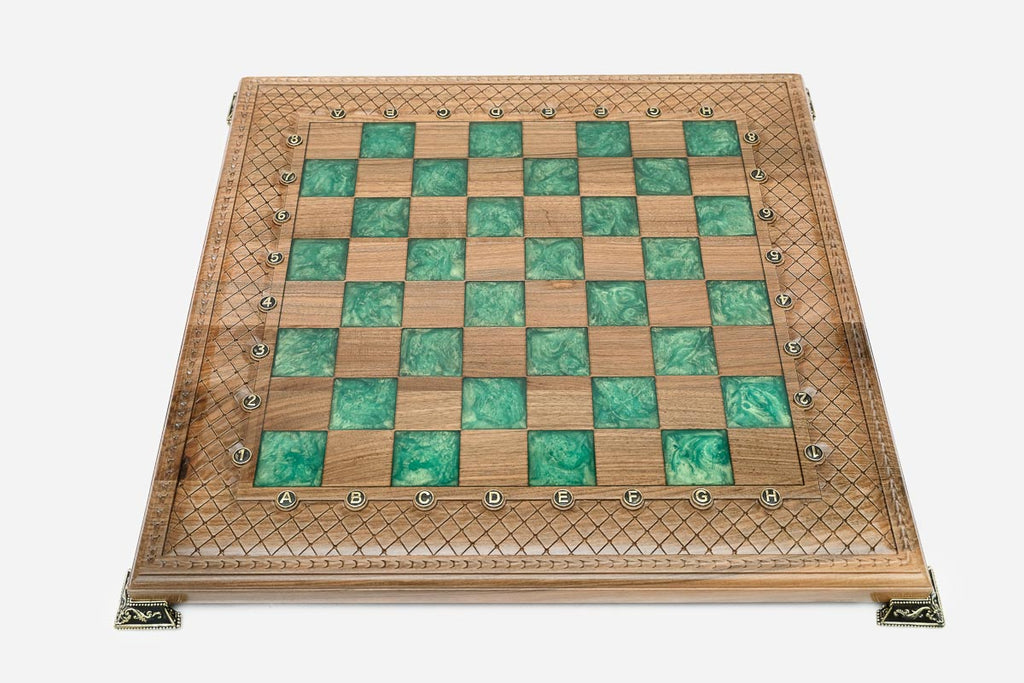Angled view of the green epoxy chess set with its marble-and-bronze pieces
