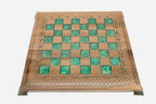 Angled view of the green epoxy chess set with its marble-and-bronze pieces