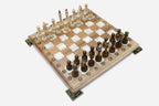 Close-up of an ornate brass corner bracket on the board