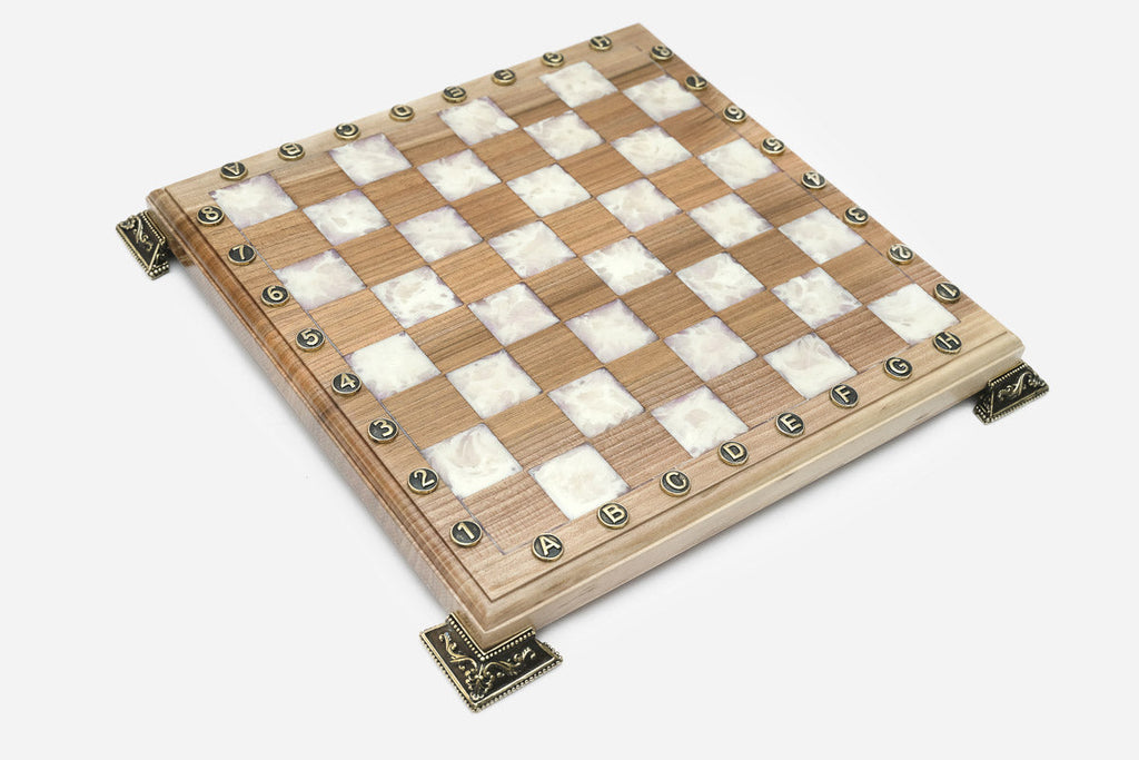 Angled view of the white epoxy chess set with its wooden pieces