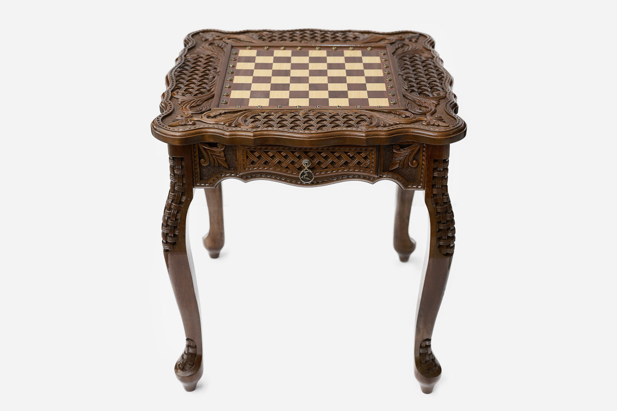 Carved chess table, bronze pieces close-up