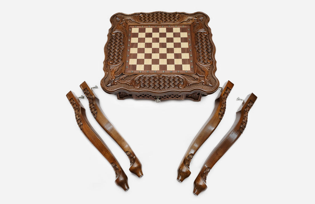 Carved chess table, playing surface with bronze pieces