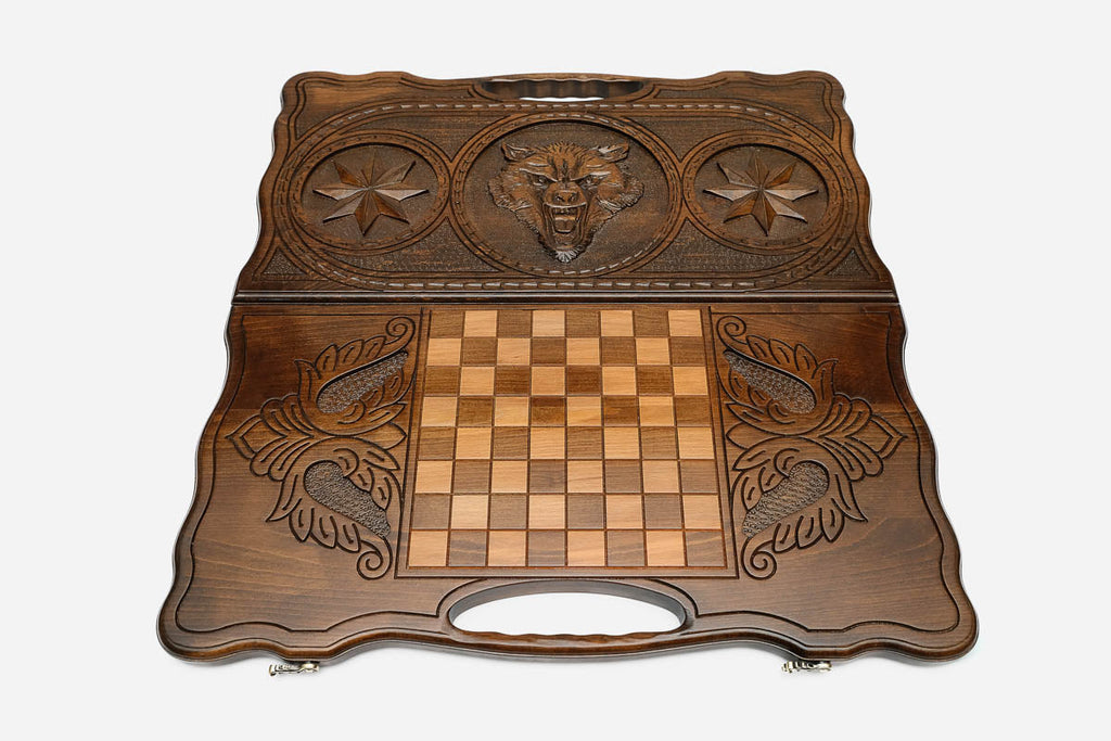 Angled view of the wolf and star carved backgammon board