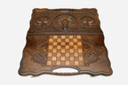 Angled view of the wolf and star carved backgammon board