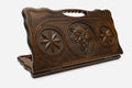 Carved beechwood backgammon board with a fierce wolf between carved stars, propped open