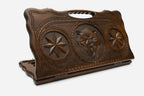Carved beechwood backgammon board with a fierce wolf between carved stars, propped open