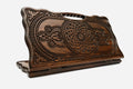 Carved beechwood backgammon board with two interlaced ornaments and a carry handle, propped open