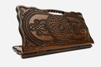 Carved beechwood backgammon board with two interlaced ornaments and a carry handle, propped open
