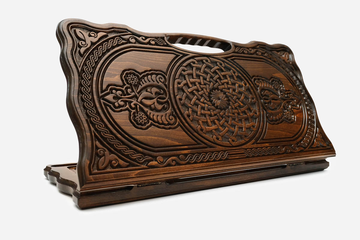 Carved beechwood backgammon board with two interlaced ornaments and a carry handle, propped open