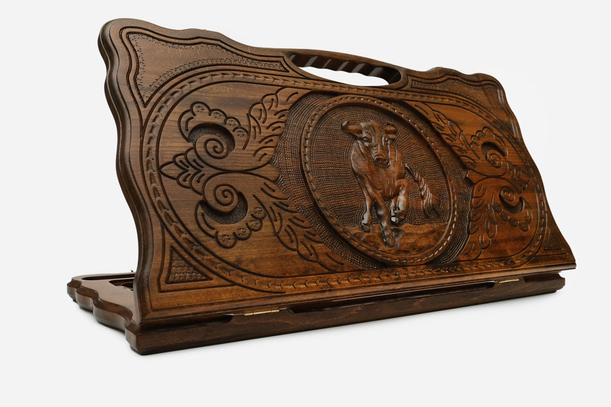 Hand-carved wooden backgammon board with an ox and a cut-out carry handle, propped open