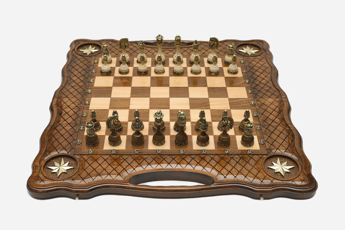Luxury carved chess set with four inlaid brass stars, lattice borders and ornate bronze pieces set up for play
