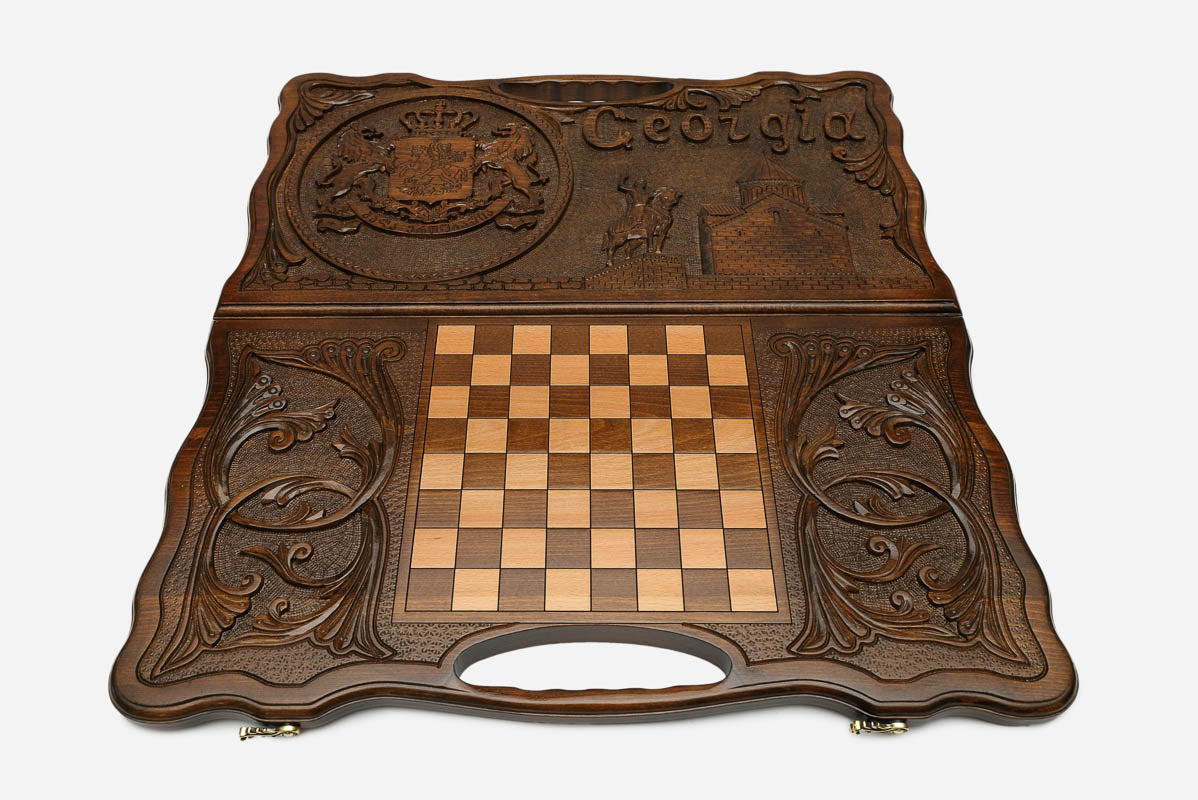 Angled view of the handmade Georgian backgammon set showing the carved lid