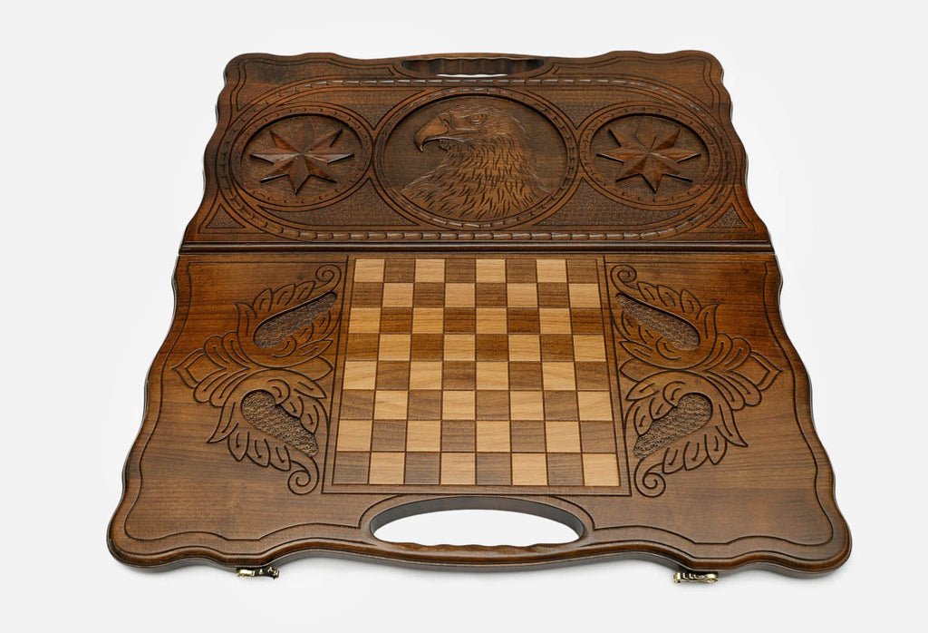 Carved eagle and octagon symbol on a wooden backgammon board with carry handle