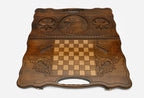 Carved eagle and octagon symbol on a wooden backgammon board with carry handle