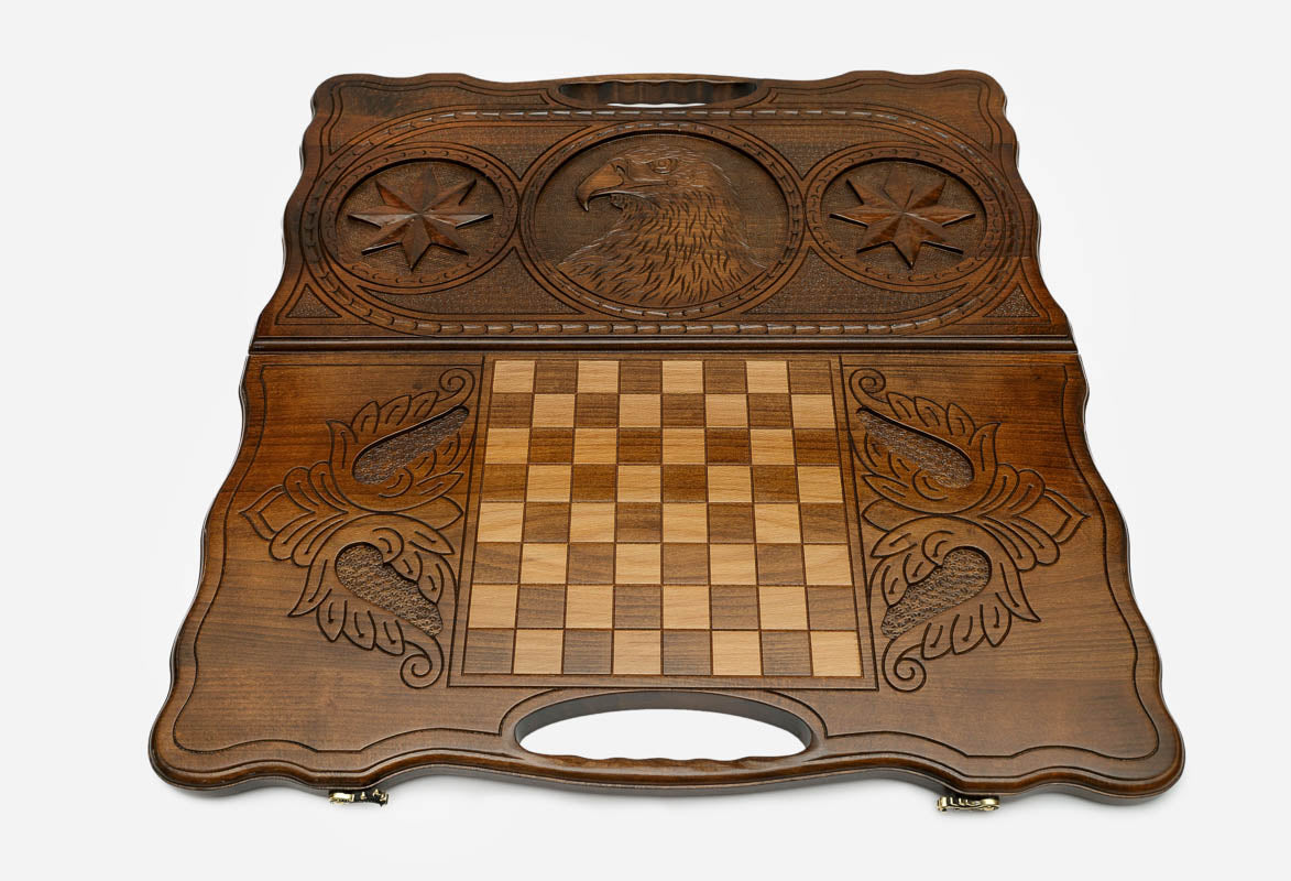 Carved eagle and octagon symbol on a wooden backgammon board with carry handle