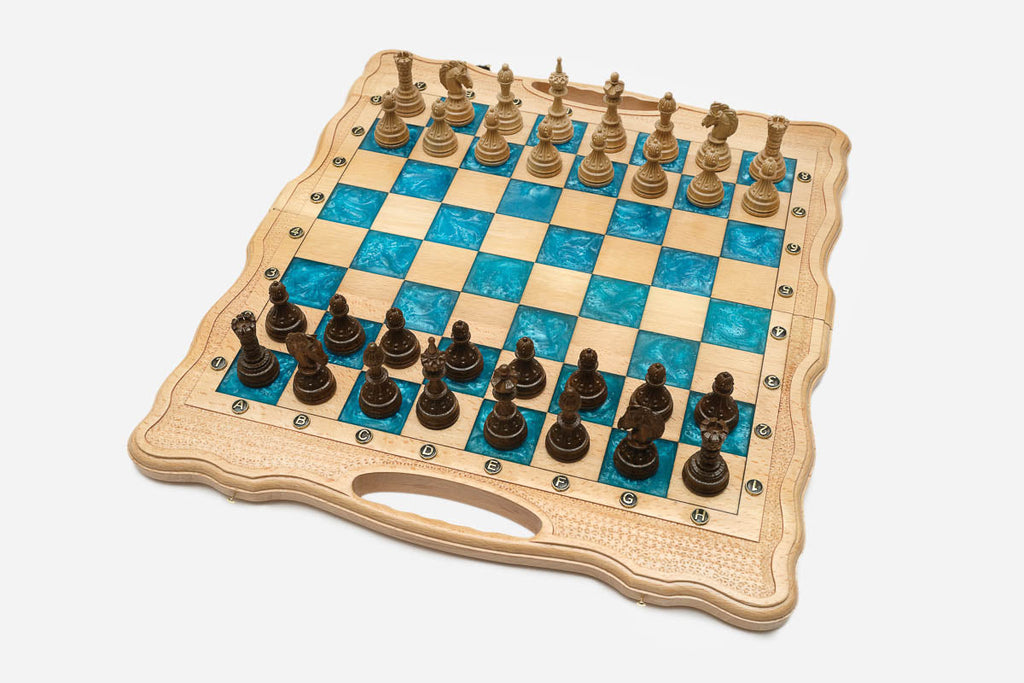 Angled view of the turquoise epoxy chess set with its carved wooden pieces