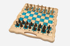 Angled view of the turquoise epoxy chess set with its carved wooden pieces