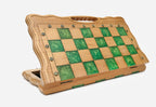 Angled view of the folding green epoxy chess board with its bronze warrior army