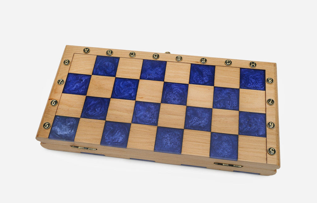 The compact blue epoxy chess set shown from an angle