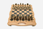 Folding chess board in pale wood with gray marbled epoxy squares and ornate bronze figural pieces set up for play