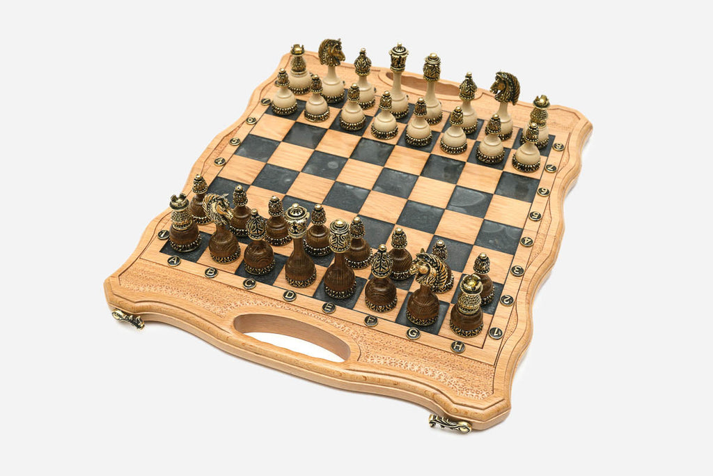Angled view of the gray epoxy chess set with its bronze pieces
