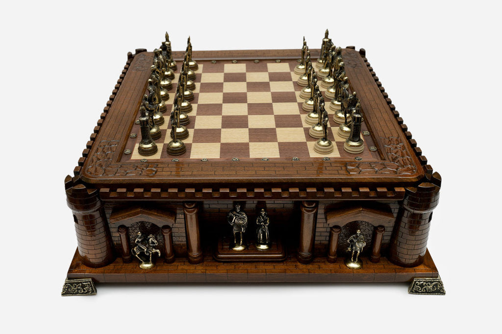Castle chess set with bronze pieces facing off in starting position, front view