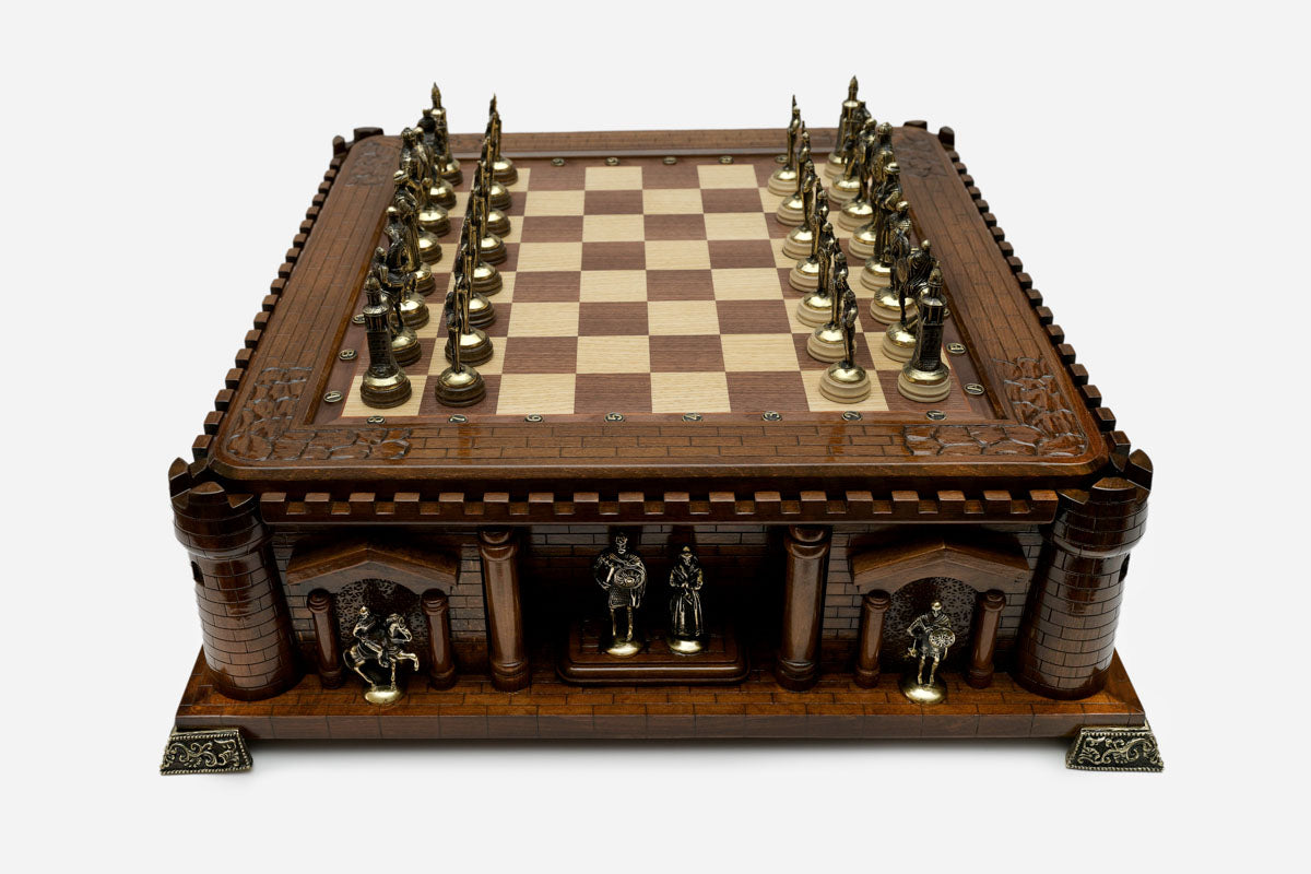 Castle chess set with bronze pieces facing off in starting position, front view