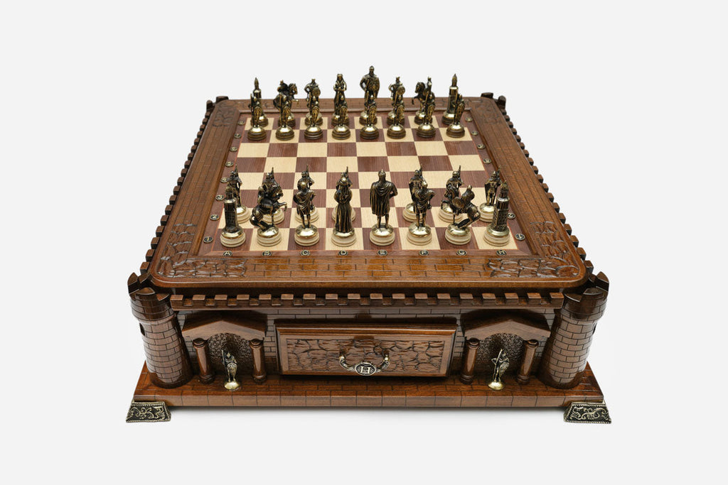Castle chess set set up for play with bronze pieces, front angled view