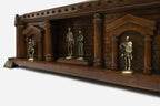 Close-up of the bronze king, queen and knight figures on the castle chess set shelf