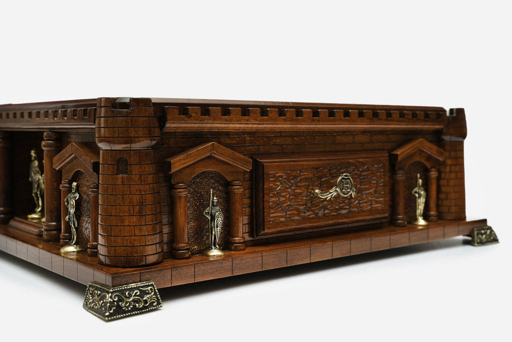 Close-up of the castle chess set side wall with the carved drawer front and knight statues