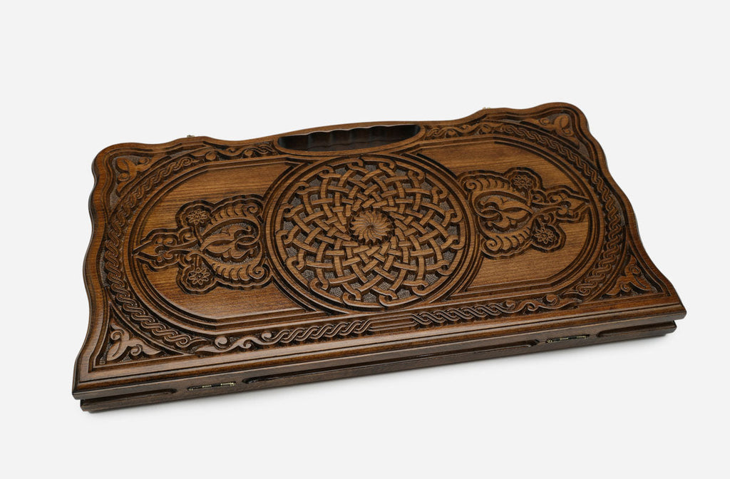 Detail of the scrollwork running between the two ornaments and the carved border