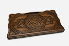 Detail of the scrollwork running between the two ornaments and the carved border