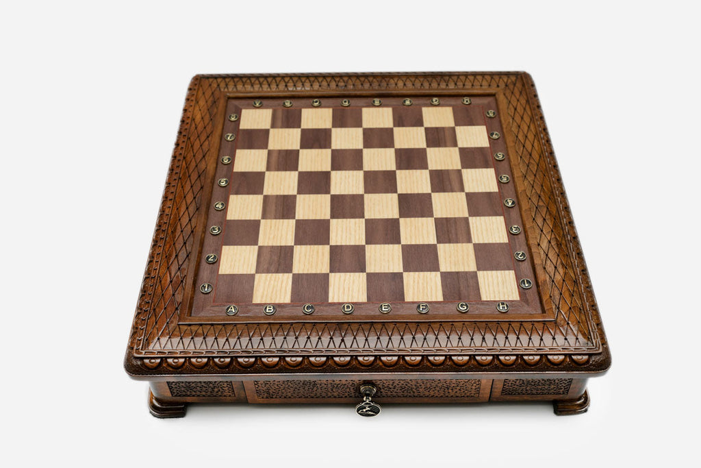 Carved chess set empty board, angled view with the drawer closed