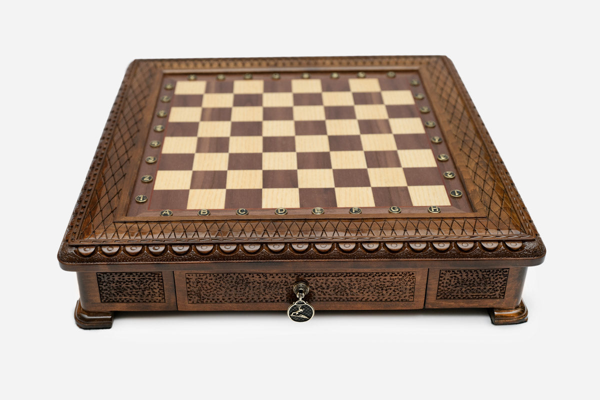 Carved chess set empty board, front view with the drawer closed