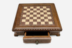 Carved chess set empty board with the storage drawer open, front view