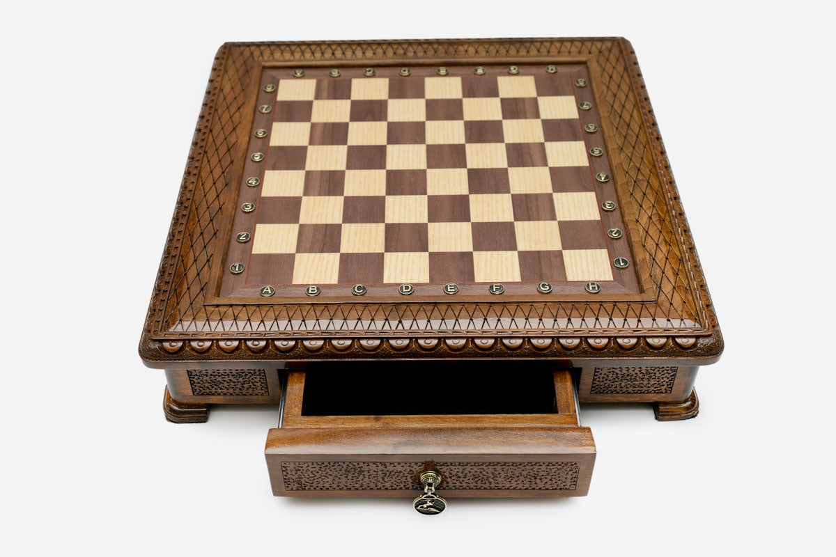 Carved chess set empty board with the storage drawer open, front view