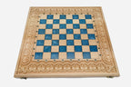 Close-up of the beech and walnut chess pieces on the blue epoxy squares
