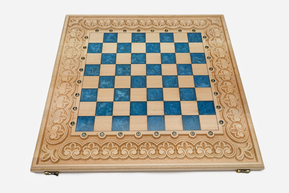 Close-up of the beech and walnut chess pieces on the blue epoxy squares