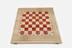 Close-up of the beech and walnut chess pieces on the red epoxy squares