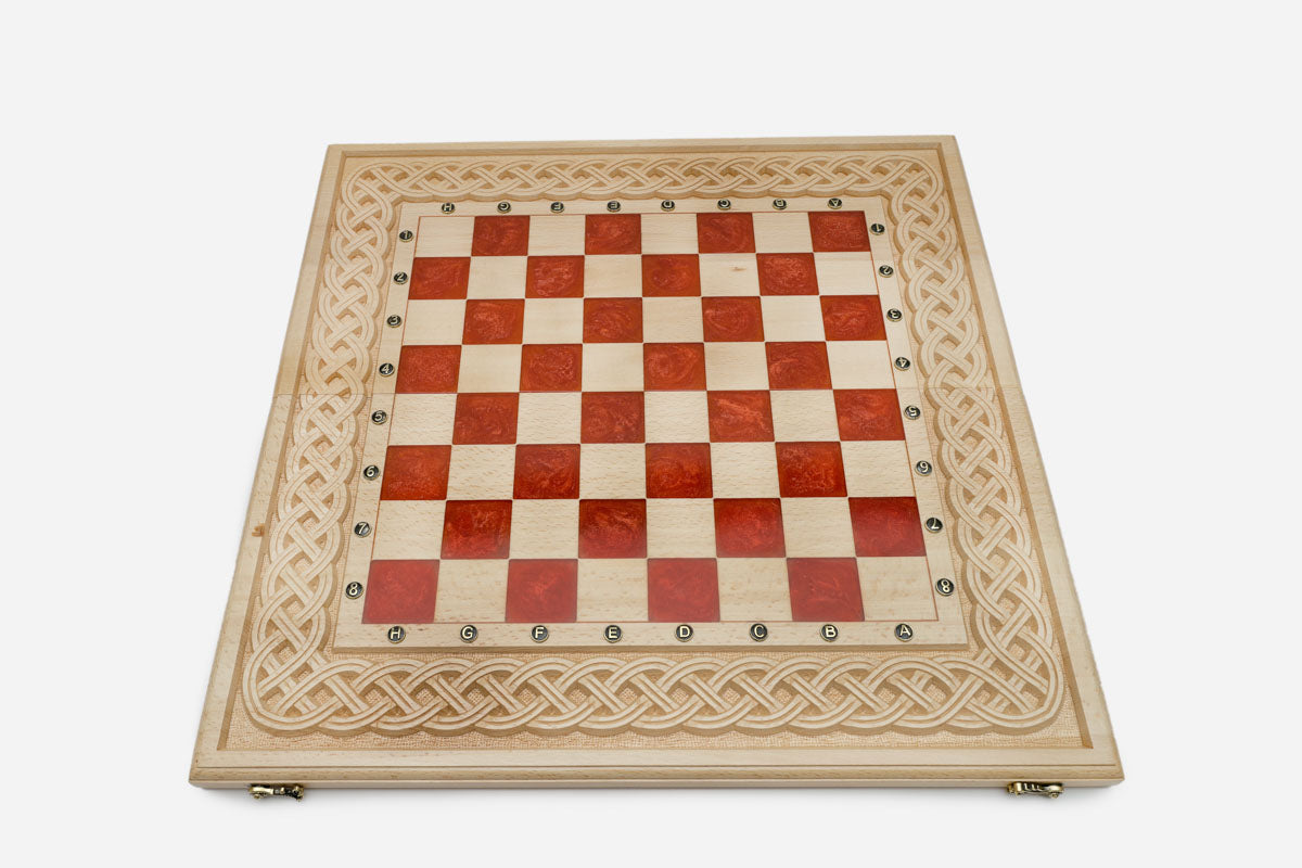Close-up of the beech and walnut chess pieces on the red epoxy squares