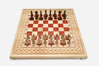 Angled view of the red epoxy chess set with its wooden pieces