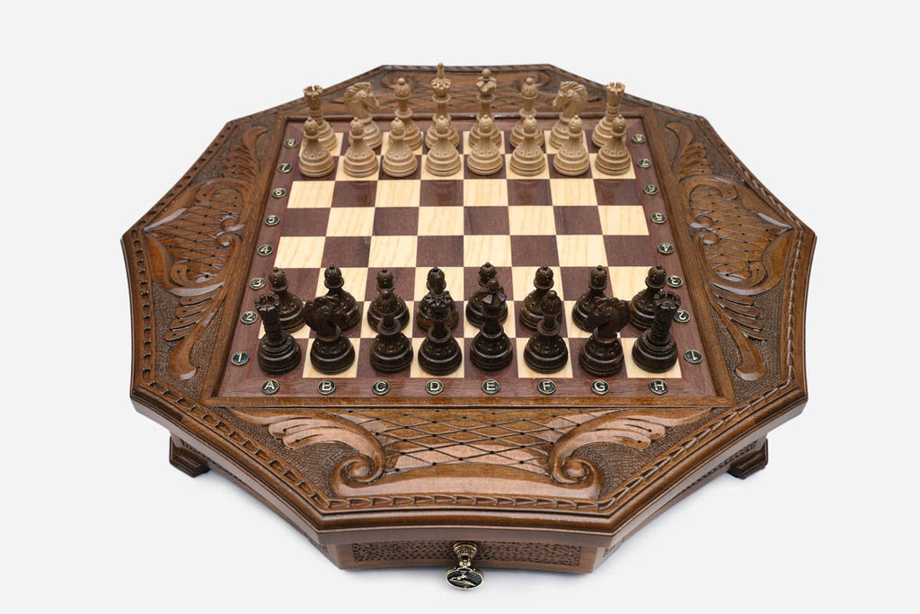 Octagonal honey-walnut chess set with detailed carved pieces set up on the board