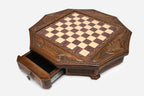 Octagonal chess set in honey-walnut finish, top angle showing ornate carved pieces arranged on the inlaid board